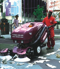 Green Machine sweeping sidewalk